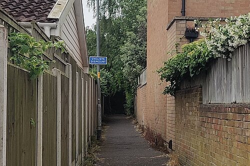 A cyclists dismount sign between Christchurch and Meadow Rise Rds.