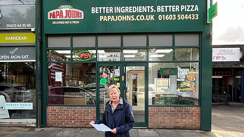 Cllr Lubbock in front of Pappa Johns delivery shop on Colman Road.